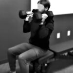 A man performing seated overhead press